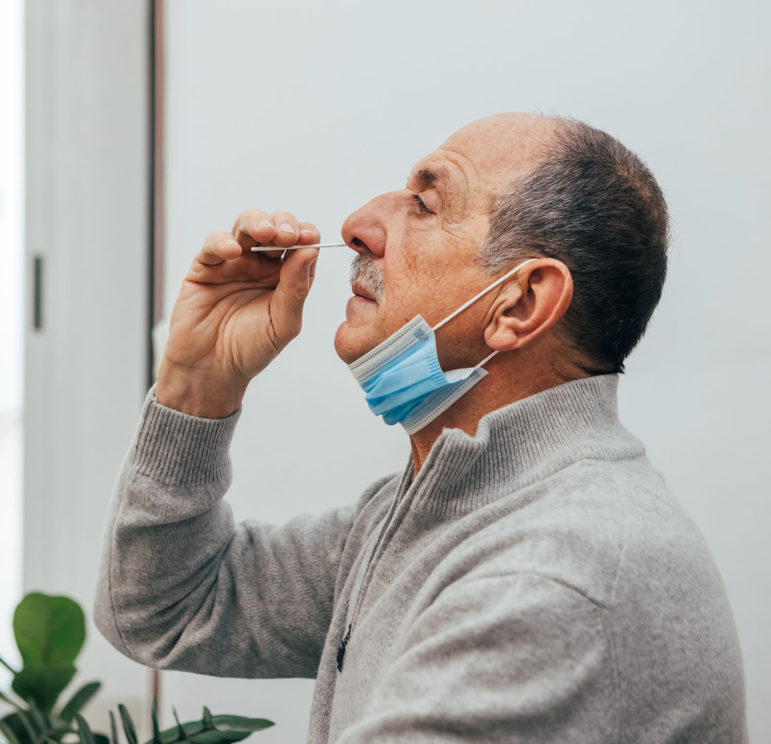 man giving himself a COVID test