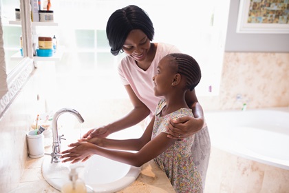 adult and child washing hands