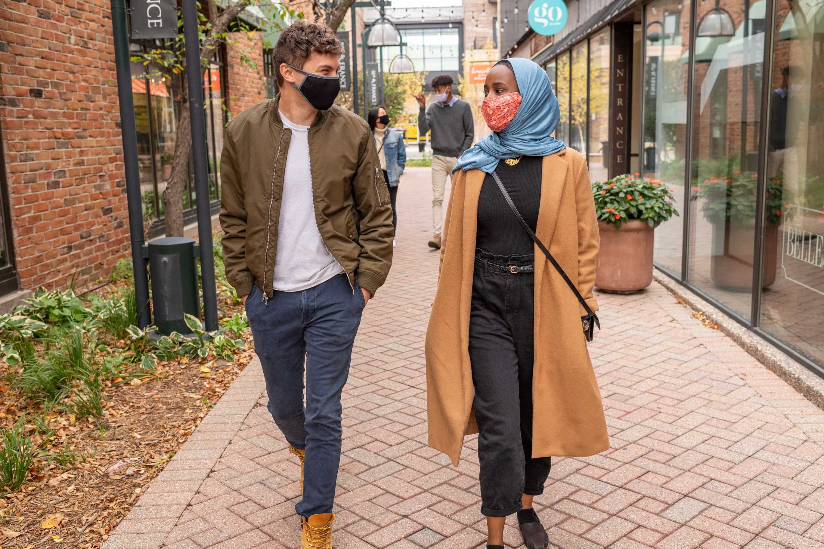 Young people walking with masks on