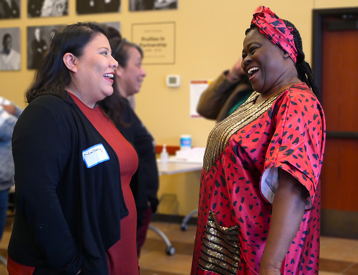 two smiling women chatting