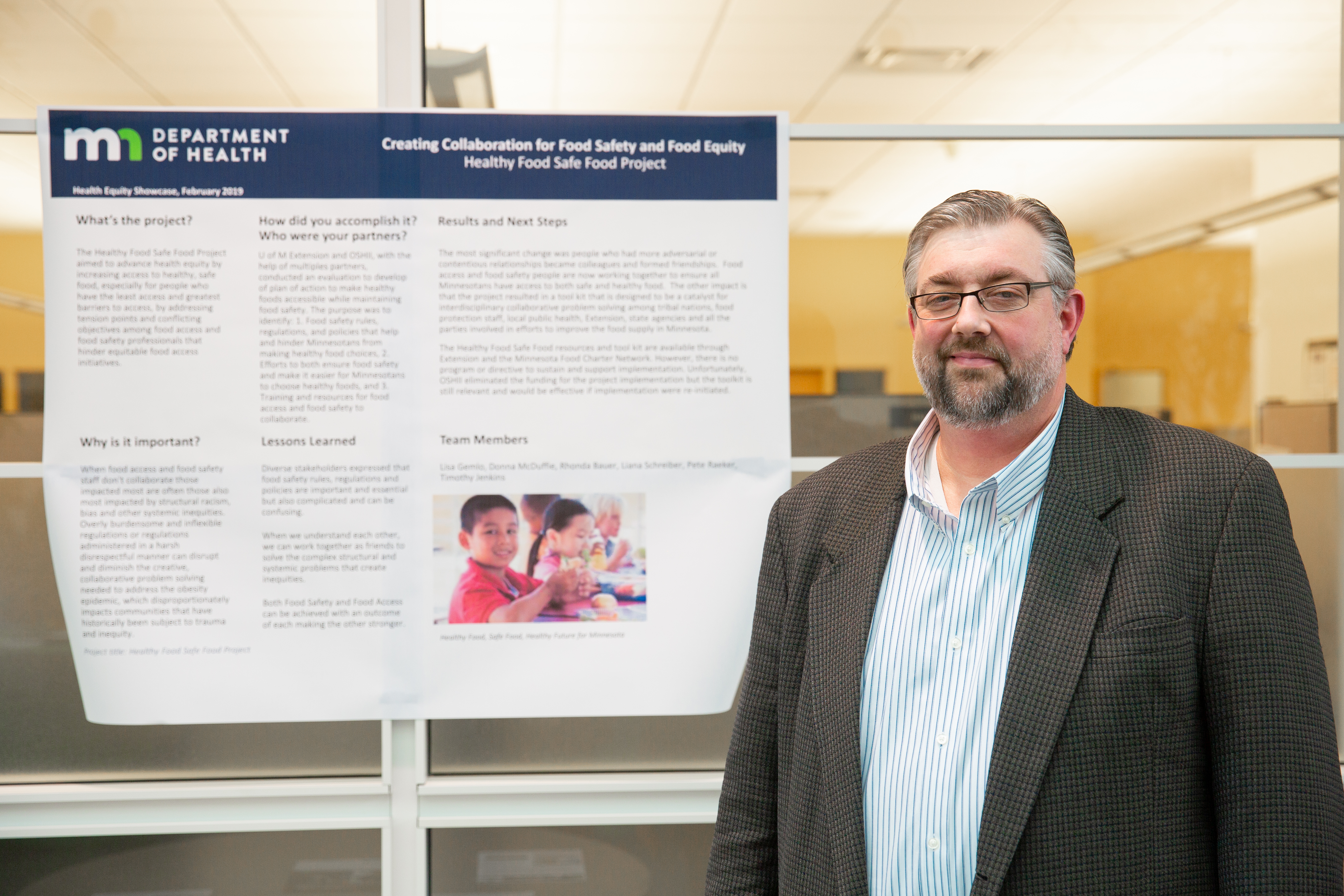 Photo of project lead with poster - food project