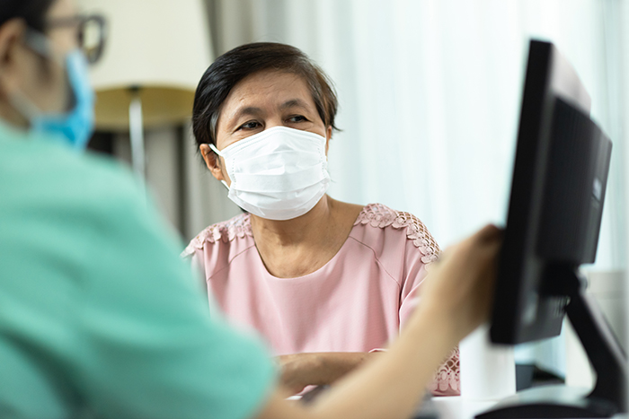 doctor reviews records with patient