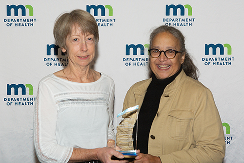 Dr. Rhonda Cady receiving award from Assistant Commissioner Mary Manning.