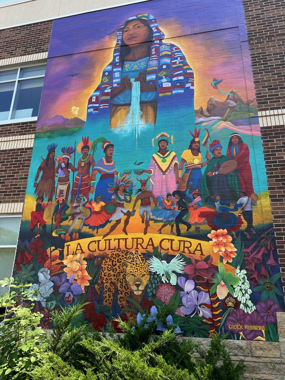 Photo of the colorful mural outside of CLUES, featuring a young Latina girl.