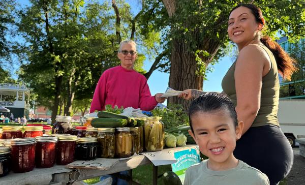 Mom and child buying produce at farmer's market