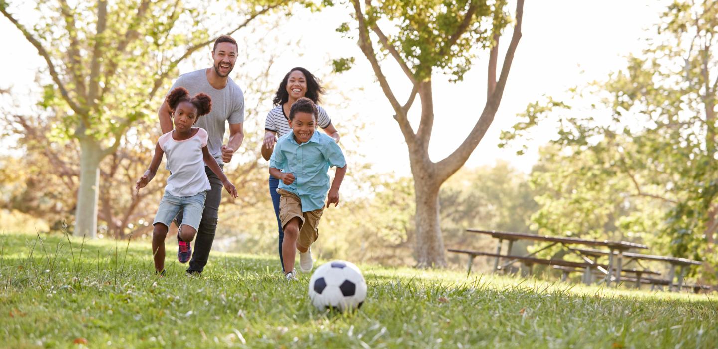 Family playing soccer