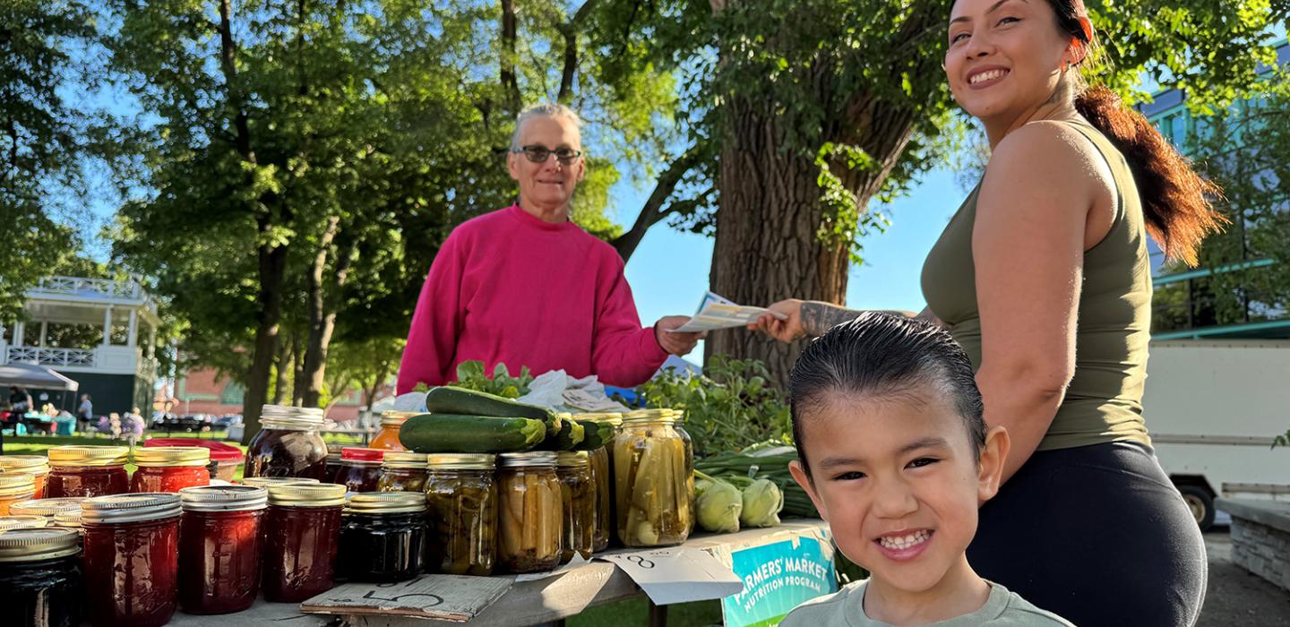Mom and child buying produce at farmer's market