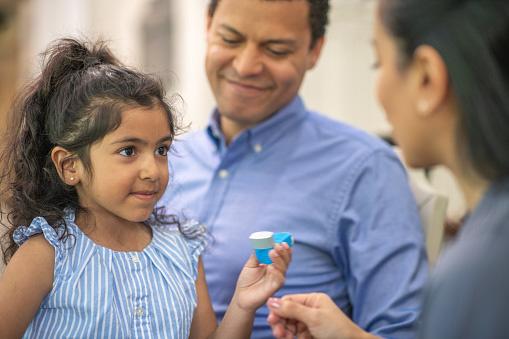 Girl with asthma inhaler. 